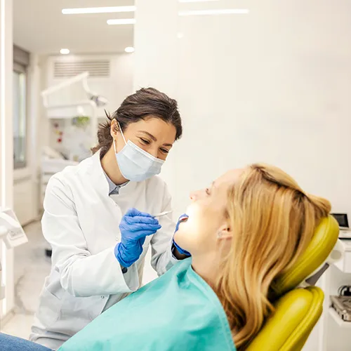 dentist using dental tools in patient's mouth